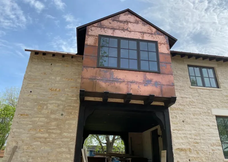 Copper metal panel facade on a stone building for Skylight Installation in Castle Pines